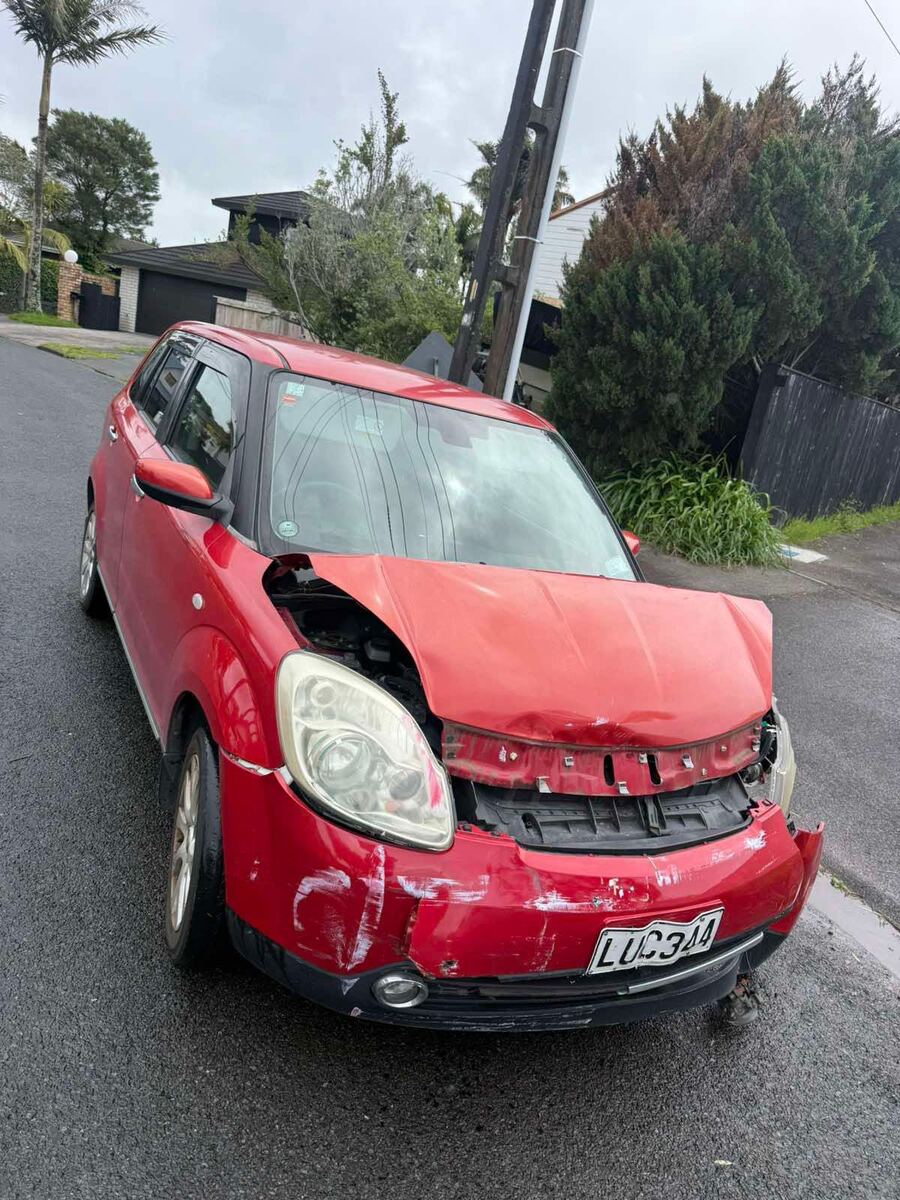 Crashed red Mitsubishi Colt collected by our junk car removal team in South Auckland
