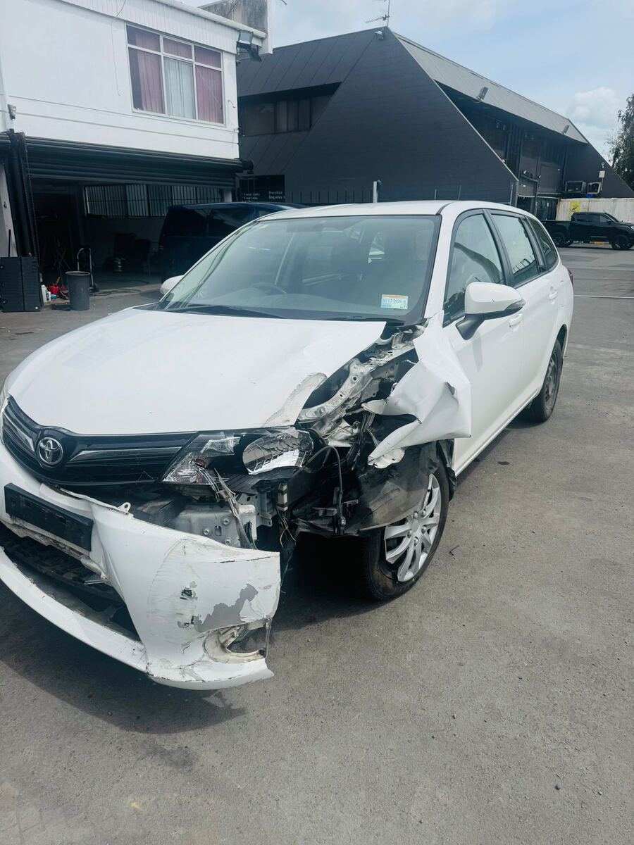 Crash-damaged Toyota Corolla Fielder with front end destroyed, bought for cash in South Auckland