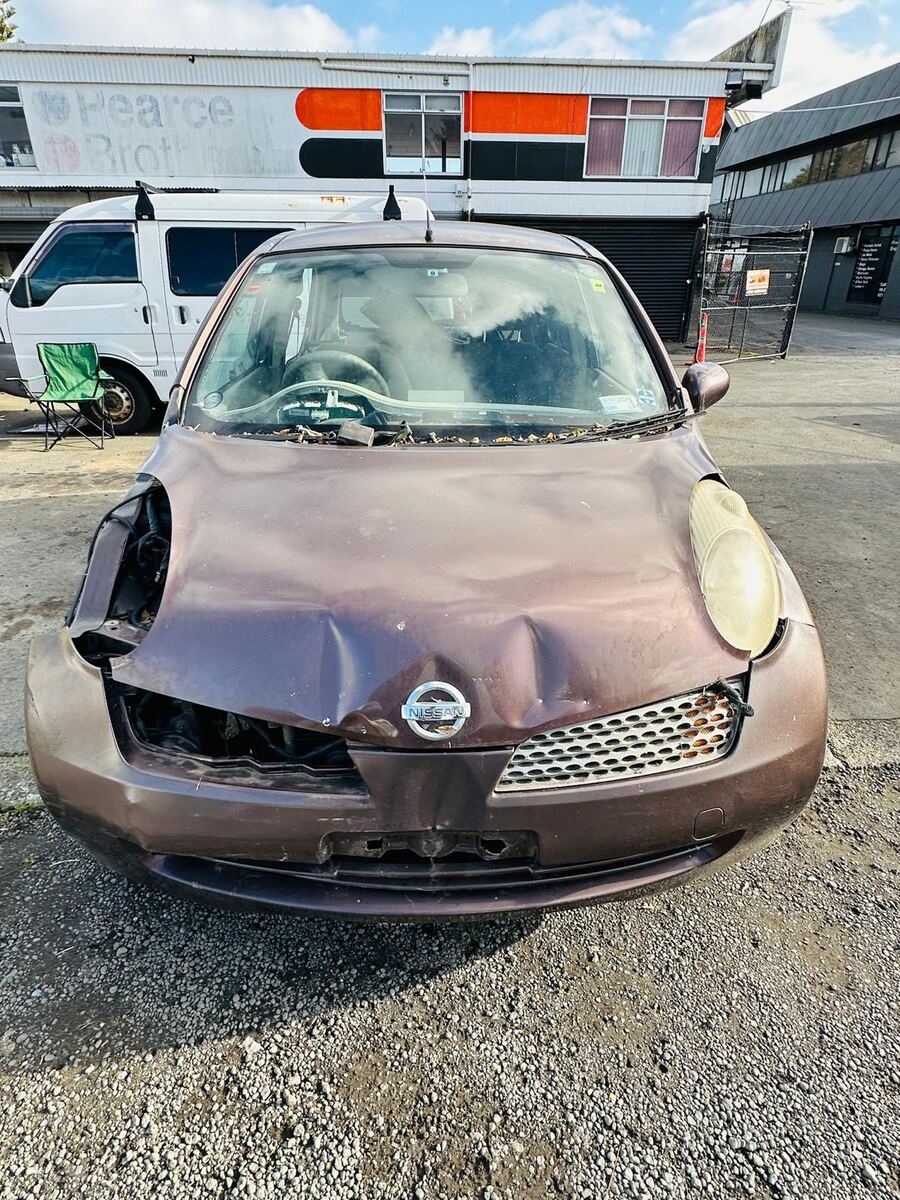 Accident-damaged Nissan March with crushed front bumper bought for cash in South Auckland