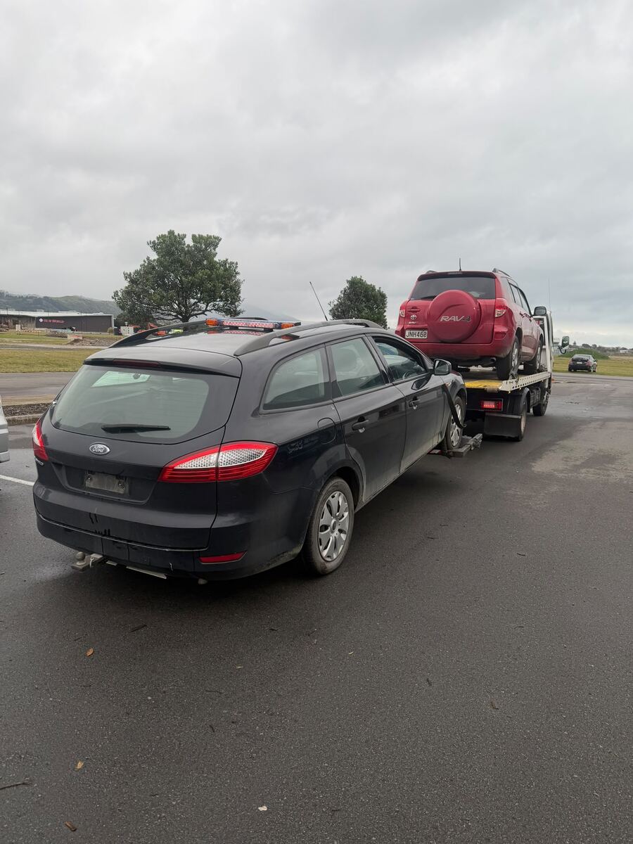 Ford Mondeo wagon waiting for collection beside our tow truck in South Auckland